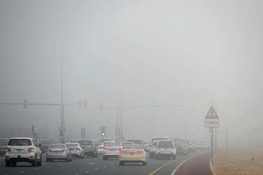 Dense morning fog reduces visibility on a highway in Abu Dhabi during the morning commute